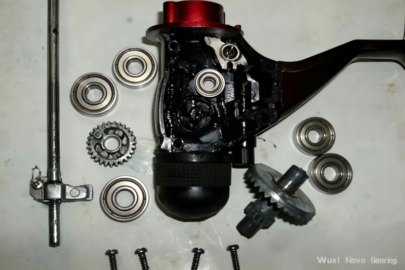 disassembled spinning fishing reel with internal miniature bearings.png